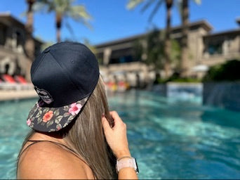 girl wearing paradise floral snapback hat
