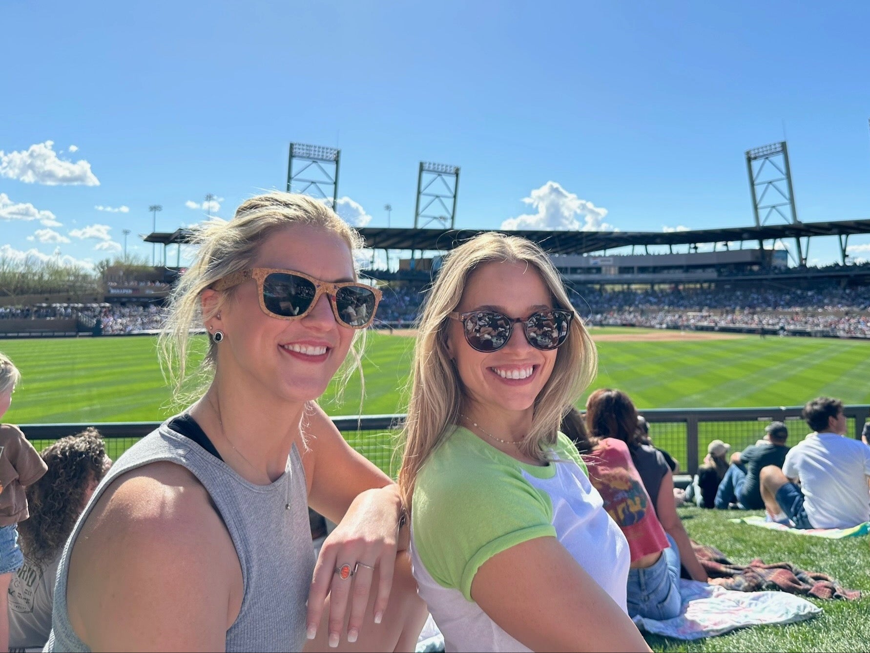 girls watching a spring training baseball game wearing natural handmade wooden cork and oak sunglasses