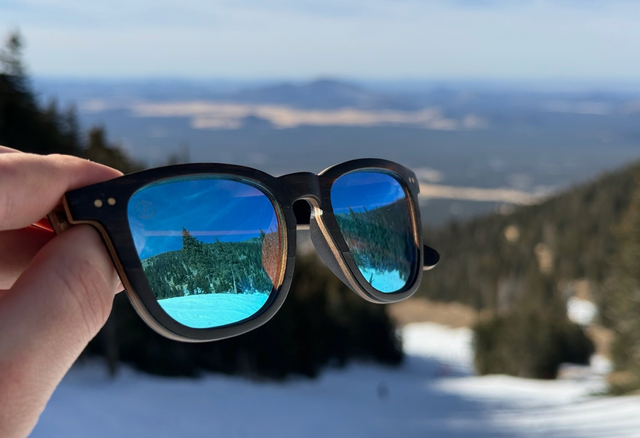 blue premium wood sunglasses being on mountain