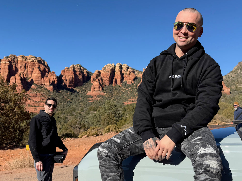 guys hanging out in sedona wearing premium wooden sunglasses and black hoodie