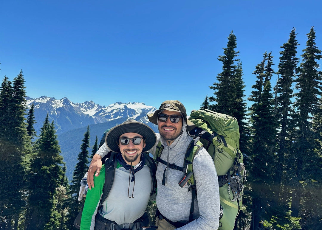 two friends hiking at olympic national park wearing natural handmade wooden sunglasses to protect their eyes