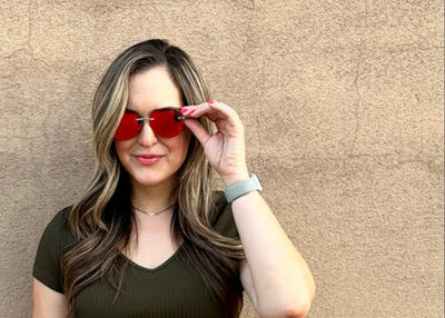girl modeling premium wooden sunglasses with reflective red lenses