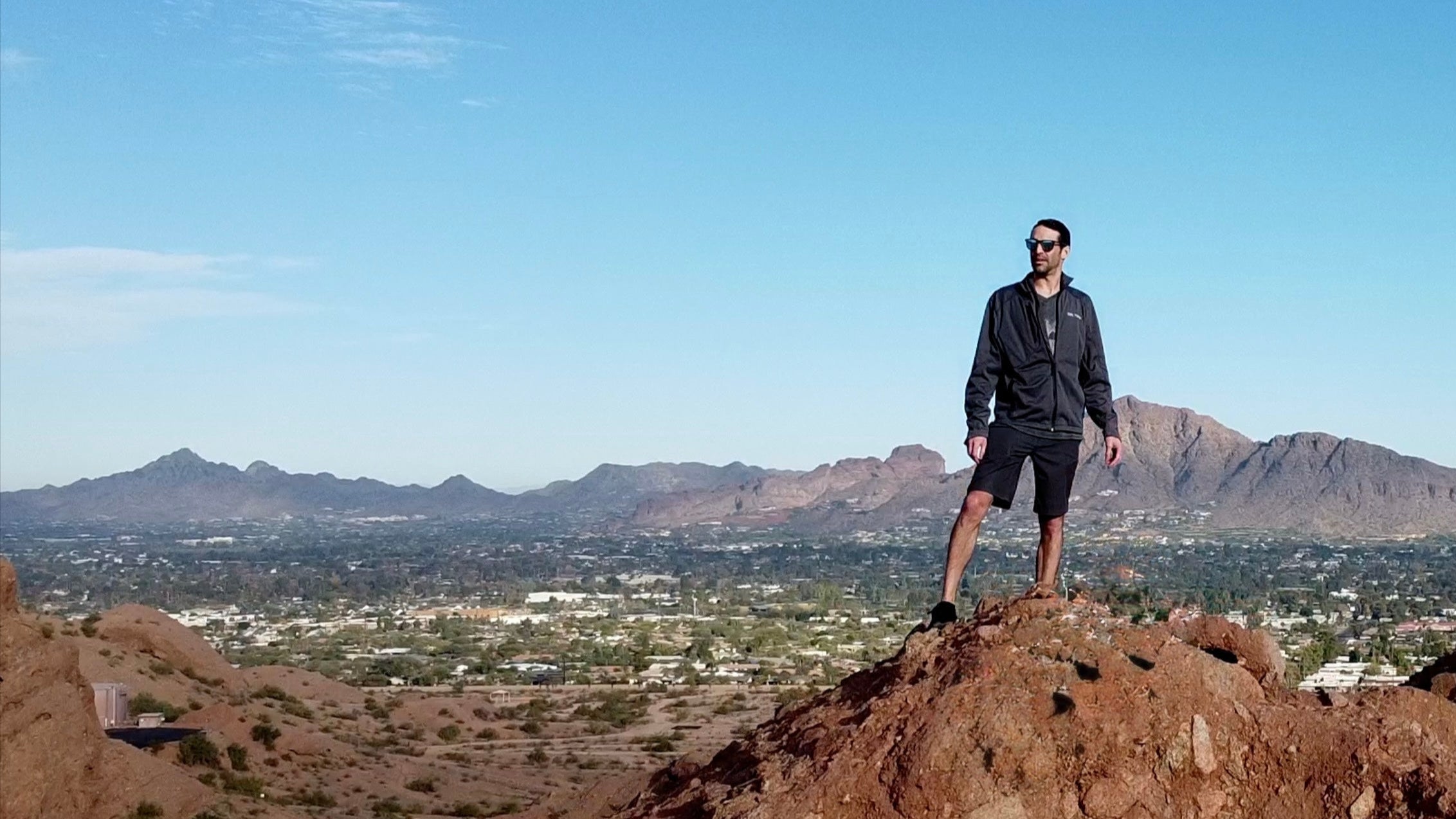 guy hiking papago mountain looking at phoenix while wearing premium sustainable wooden sunglasses