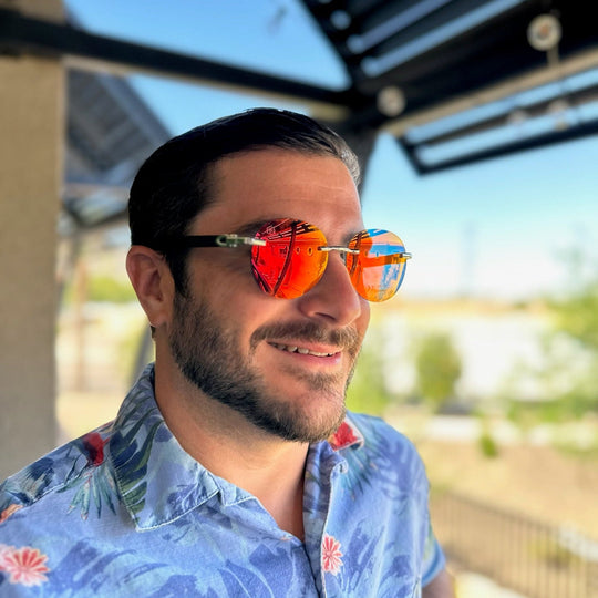 Guy trying on bright red environmentally friendly wooden sunglasses