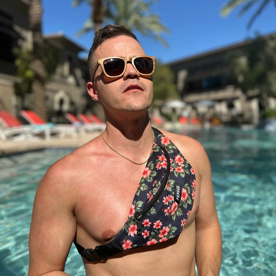 guy wearing Paradise Belt Bag and protecting his eyes with premium wooden sunglasses at pool party